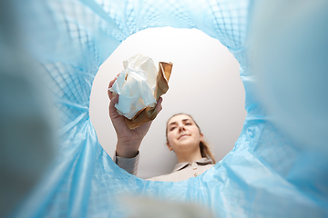 Image showing hand throwing paper into trash can