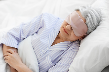 Image showing senior woman with eye mask sleeping in bed at home