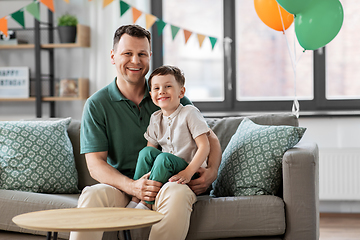 Image showing happy father and little son at home birthday party