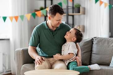 Image showing happy father and little son at home birthday party