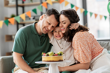 Image showing happy family with birthday cake hugging at home