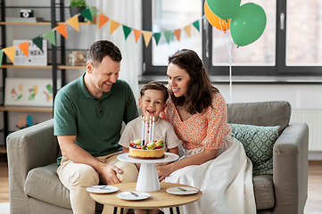 Image showing happy family with birthday cake at home