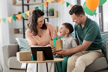 Image showing happy family giving present to little son at home