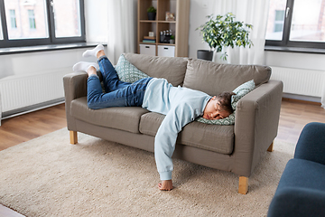 Image showing young man sleeping on sofa at home