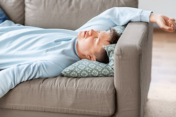 Image showing young man sleeping on sofa at home