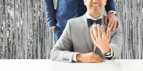 Image showing close up of male gay couple with wedding rings on