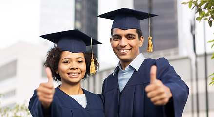 Image showing happy students or bachelors showing thumbs up