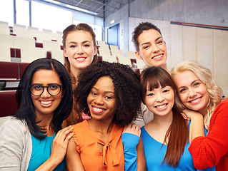 Image showing group of happy student women hugging at university