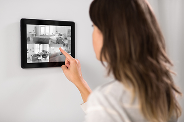 Image showing woman having video control from tablet pc at home