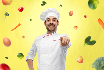 Image showing happy smiling male chef in toque pointing to you