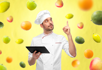 Image showing male chef with tablet computer pointing finger up