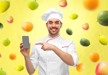 Image showing happy smiling male chef showing smartphone