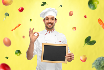 Image showing happy smiling male chef showing chalkboard