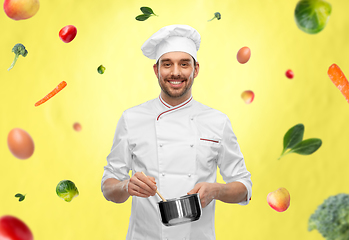 Image showing happy smiling male chef with saucepan cooking food