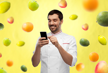 Image showing happy smiling male chef with smartphone