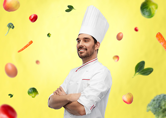 Image showing happy smiling male chef in toque with crossed arms