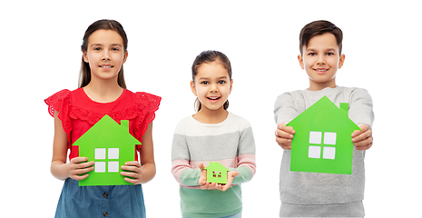 Image showing smiling children holding green house icons