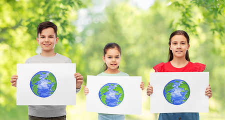 Image showing smiling children holding drawing of earth planet