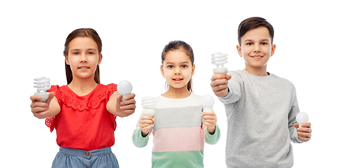 Image showing smiling children comparing different light bulbs