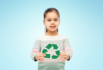 Image showing smiling girl holding green recycling sign on blue