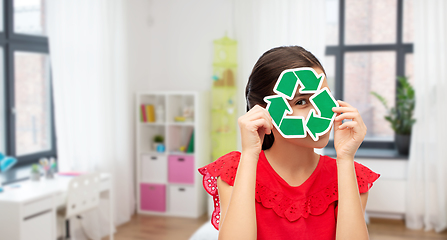 Image showing smiling girl holding green recycling sign