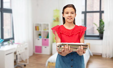 Image showing smiling girl with magazines sorting paper waste