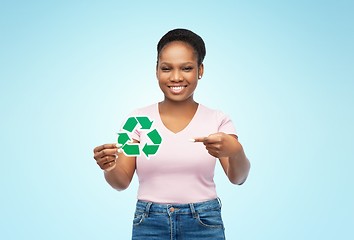 Image showing smiling asian woman holding green recycling sign