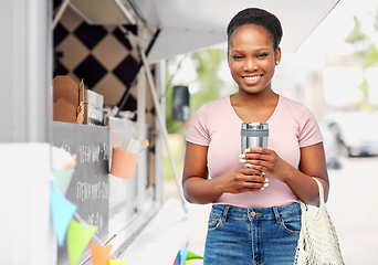 Image showing woman with tumbler and string bag ober food truck