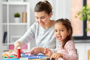 Image showing daughter with mother making applique at home