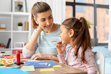 Image showing daughter with mother making applique at home