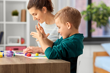 Image showing mother and son playing with modeling clay at home