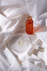 Image showing bottle of serum and dropper on white sheet