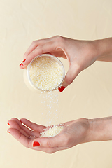 Image showing hands with bath salt in jar