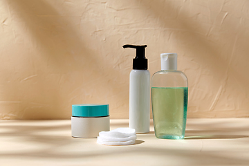 Image showing body milk, lotion, moisurizer and cotton pads