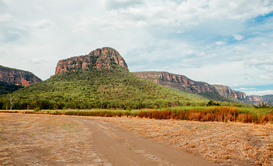 Image showing Dirt road in Capertee Valley with rising rocky mountain in dista