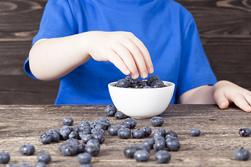 Image showing child with blueberry