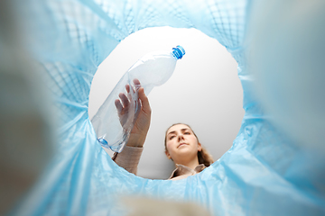 Image showing woman throwing plastic bottle into trash can