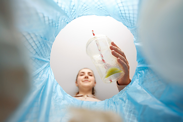 Image showing woman throwing plastic cup into trash can