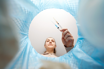 Image showing woman throwing used syringes into trash can