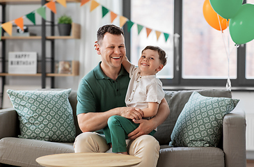 Image showing happy father and little son at home birthday party