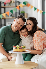 Image showing happy family with birthday cake hugging at home