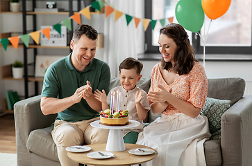 Image showing happy family with birthday cake at home