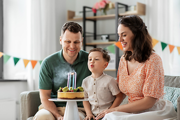 Image showing happy family with birthday cake at home