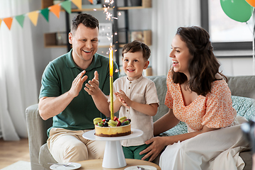 Image showing happy family with birthday cake at home