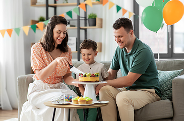 Image showing happy family with birthday cake at home