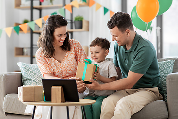 Image showing happy family giving present to little son at home