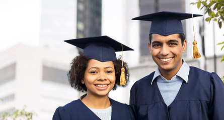 Image showing happy students or bachelors in mortar boards