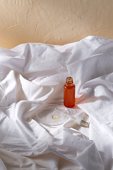 Image showing bottle of serum and dropper on white sheet