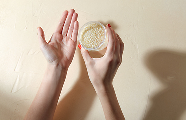 Image showing hands with bath salt in jar