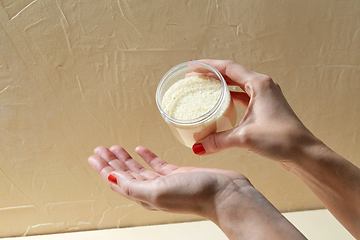 Image showing hands with bath salt in jar